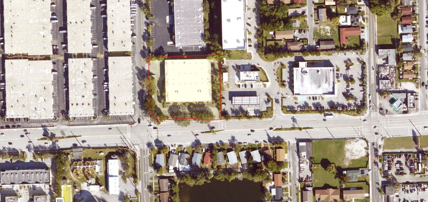 Aerial view of the property outlined in red on Stirling Road, surrounded by industrial buildings and a signalized intersection
